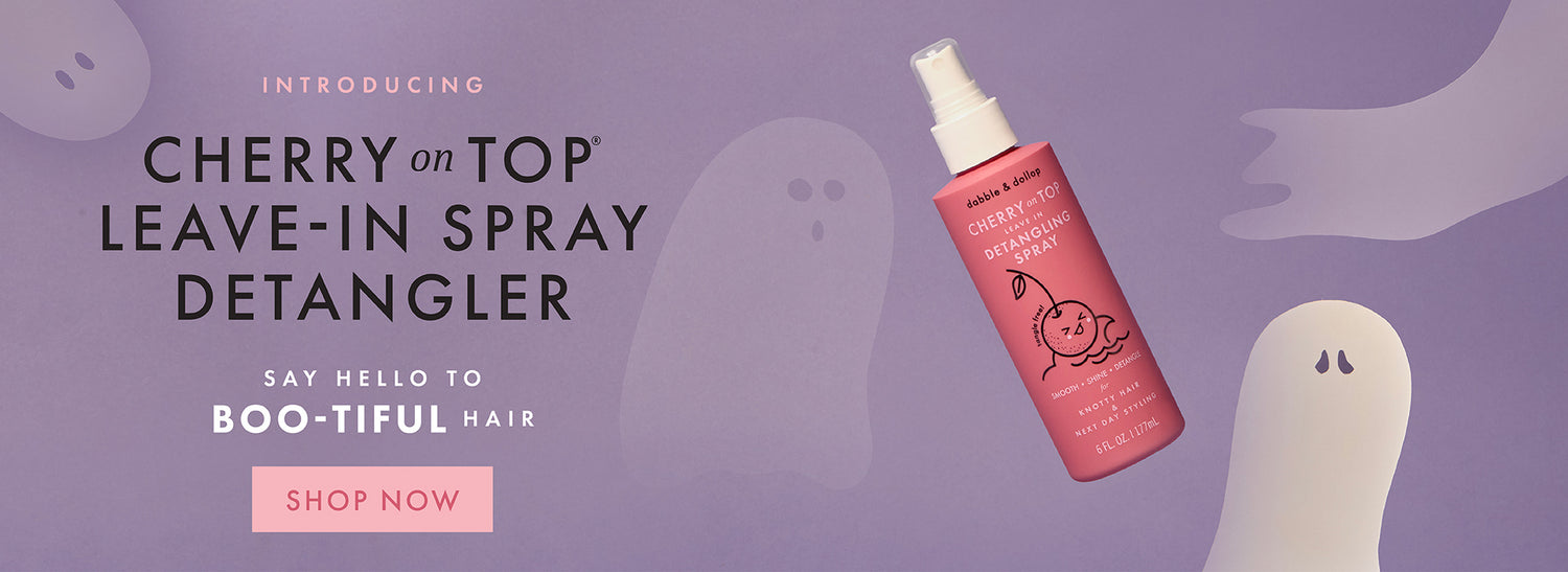 All new Cherry on Top Leave-In Spray Detangler bottle with ghost illustrations on a purple background