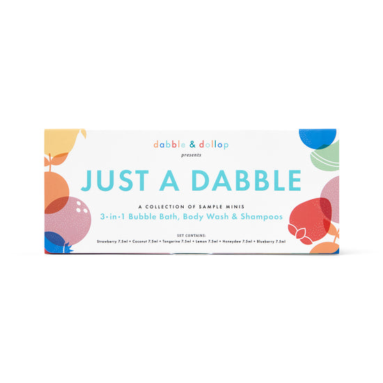 A colorful image shows a rectangular box labeled Just a Dabble Minis Set by Dabble & Dollop. It’s a 3-in-1 Bubble Bath, Body Wash & Shampoo featuring Strawberry, Coconut, Tangerine, Lemon, Honeydew, and Blueberry scents in travel-friendly mini sizes with abstract shapes.