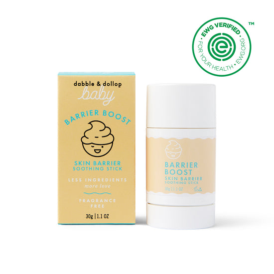 A yellow and blue Dabble & Dollop Barrier Boost Skin Barrier Soothing Stick box stands by the matching soothing stick. Both feature a swirl graphic, “fragrance free,” and an EWG VERIFIED seal in the top right corner.