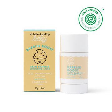 A yellow and blue Dabble & Dollop Barrier Boost Skin Barrier Soothing Stick box stands by the matching soothing stick. Both feature a swirl graphic, “fragrance free,” and an EWG VERIFIED seal in the top right corner.