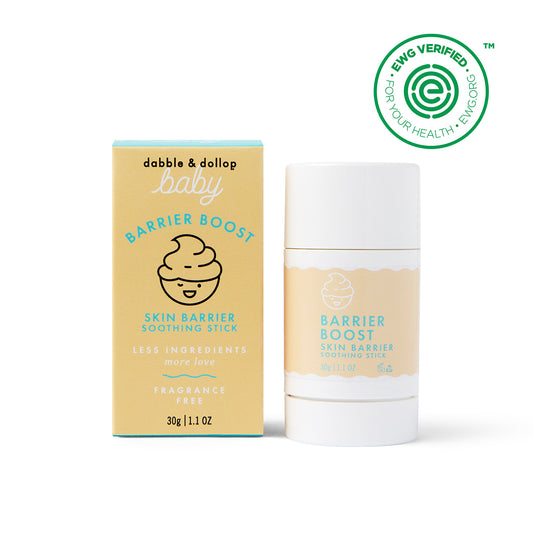 A yellow and blue Dabble & Dollop Barrier Boost Skin Barrier Soothing Stick box stands by the matching soothing stick. Both feature a swirl graphic, “fragrance free,” and an EWG VERIFIED seal in the top right corner.
