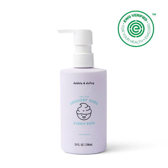 A lavender 10 fl. oz. pump bottle of Dabble & Dollop Sensory Suds™ Bubble Bath features a gentle bubbles icon and an EWG VERIFIED™ green seal in the top right corner.