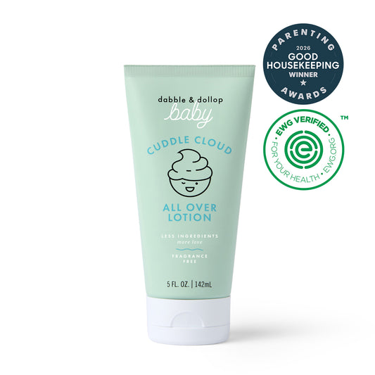 Light green tube of Dabble & Dollop Cuddle Cloud™ All Over Lotion—a gentle, fragrance-free baby lotion for hydration, featuring award and certification badges such as Good Housekeeping Winner 2026 and EWG VERIFIED for health and environmental safety.