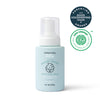 A blue bottle of Dabble & Dollop Lullaby Lather™ Hair & Body Wash appears alongside parenting award and EWG Verified logos. This gentle cleanser, featuring a convenient pump top and an illustrated baby on the label, is the perfect choice for delicate skin.