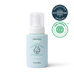 A blue bottle of Dabble & Dollop Lullaby Lather™ Hair & Body Wash appears alongside parenting award and EWG Verified logos. This gentle cleanser, featuring a convenient pump top and an illustrated baby on the label, is the perfect choice for delicate skin.