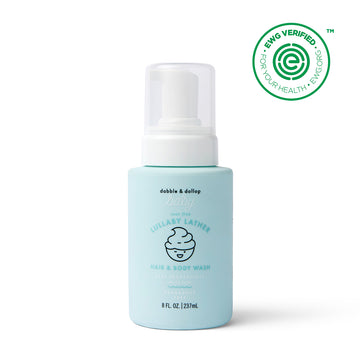 A light blue 8 fl oz bottle of Dabble & Dollop Lullaby Lather™ Hair & Body Wash with a pump top, labeled fragrance-free and gentle for babies. The EWG Verified logo is in the top right corner.