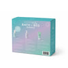A pastel-colored box labeled Baby Bath to Bed Gift Set by Dabble & Dollop contains three baby bath products arranged in steps: Cleanse, Soak, and Cuddle. Specially designed as a baby bath gift set, the packaging showcases product images, clear instructions, and playful baby-themed illustrations. Ideal for sensitive baby skin, each item is crafted with gentle ingredients for a nourishing and safe routine.