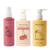 Three bottles of Dabble & Dollop hair products: Detangler with pump, Conditioner with cherry graphics and pump, and Lemon Gel Shampoo with lemon graphic and pump top.