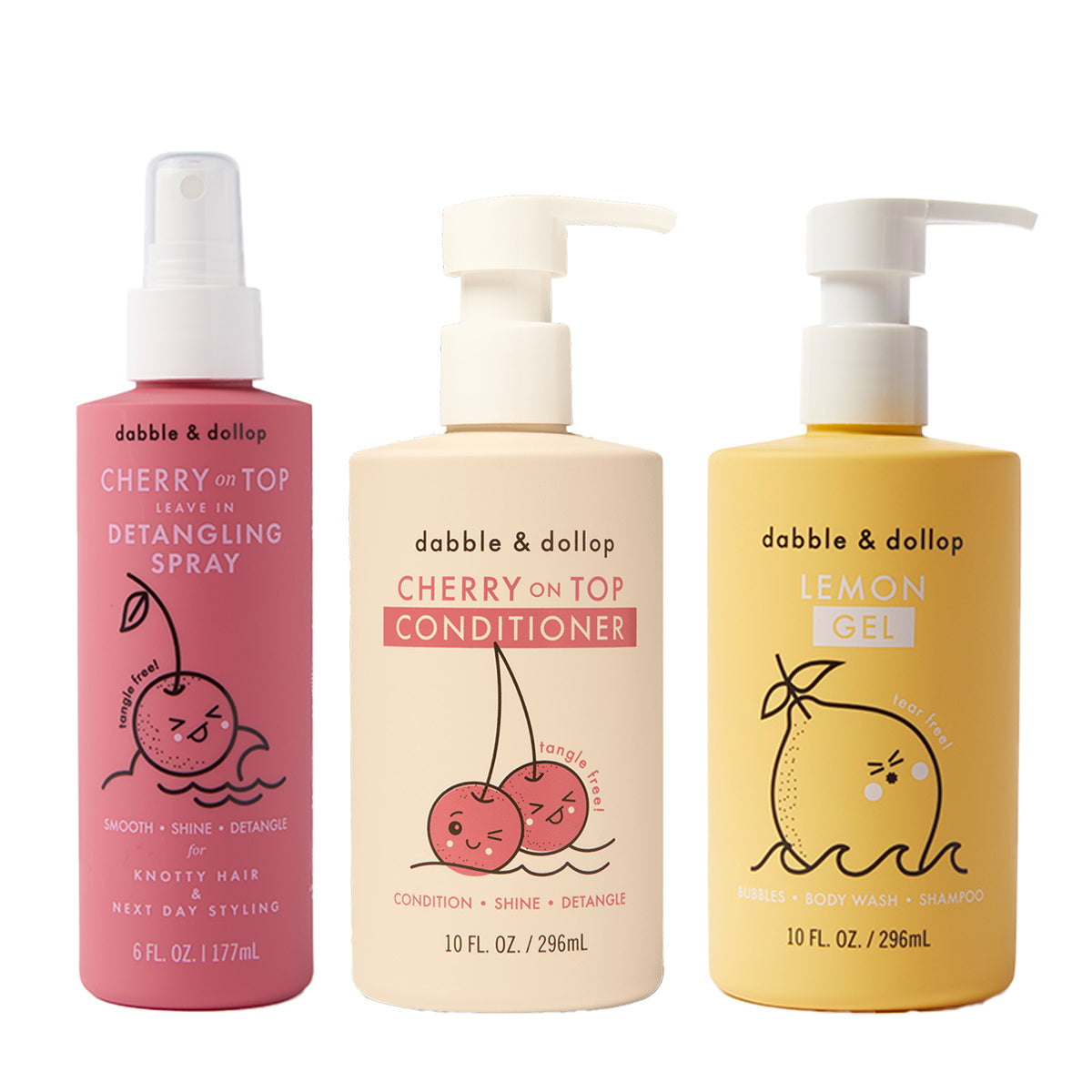 Three bottles of Dabble & Dollop hair products: Detangler with pump, Conditioner with cherry graphics and pump, and Lemon Gel Shampoo with lemon graphic and pump top.