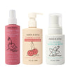 Three bottles of Dabble & Dollop Detangler and Conditioner: pink Cherry on Top Detangling Spray, beige Cherry on Top Conditioner, and white All Natural Vanilla Whip, all featuring playful fruit illustrations.