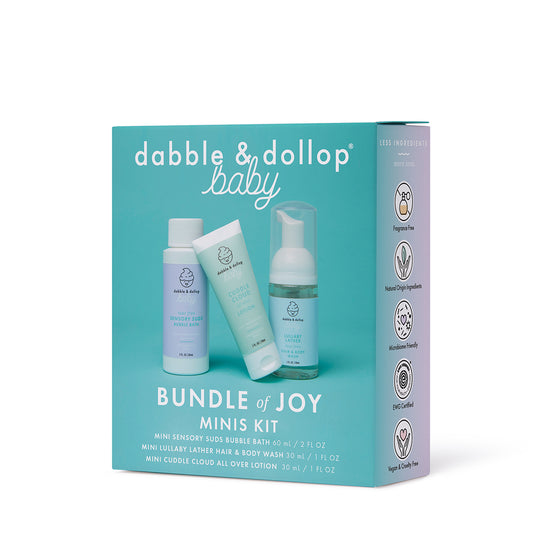 The Dabble & Dollop Bundle of Joy Minis Kit is shown in a turquoise box with three travel-size baby care products: bubble bath, wash, and lotion. The packaging highlights gentle, fragrance-free formulas.