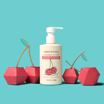 Dabble & Dollop Cherry on Top Conditioner bottle with cherry-themed packaging on a teal background