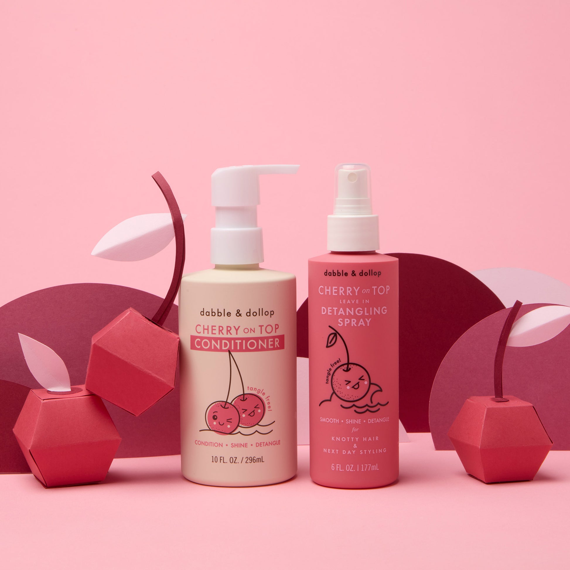 Cherry on Top Detangling Duo Bundle in studio with paper cherries