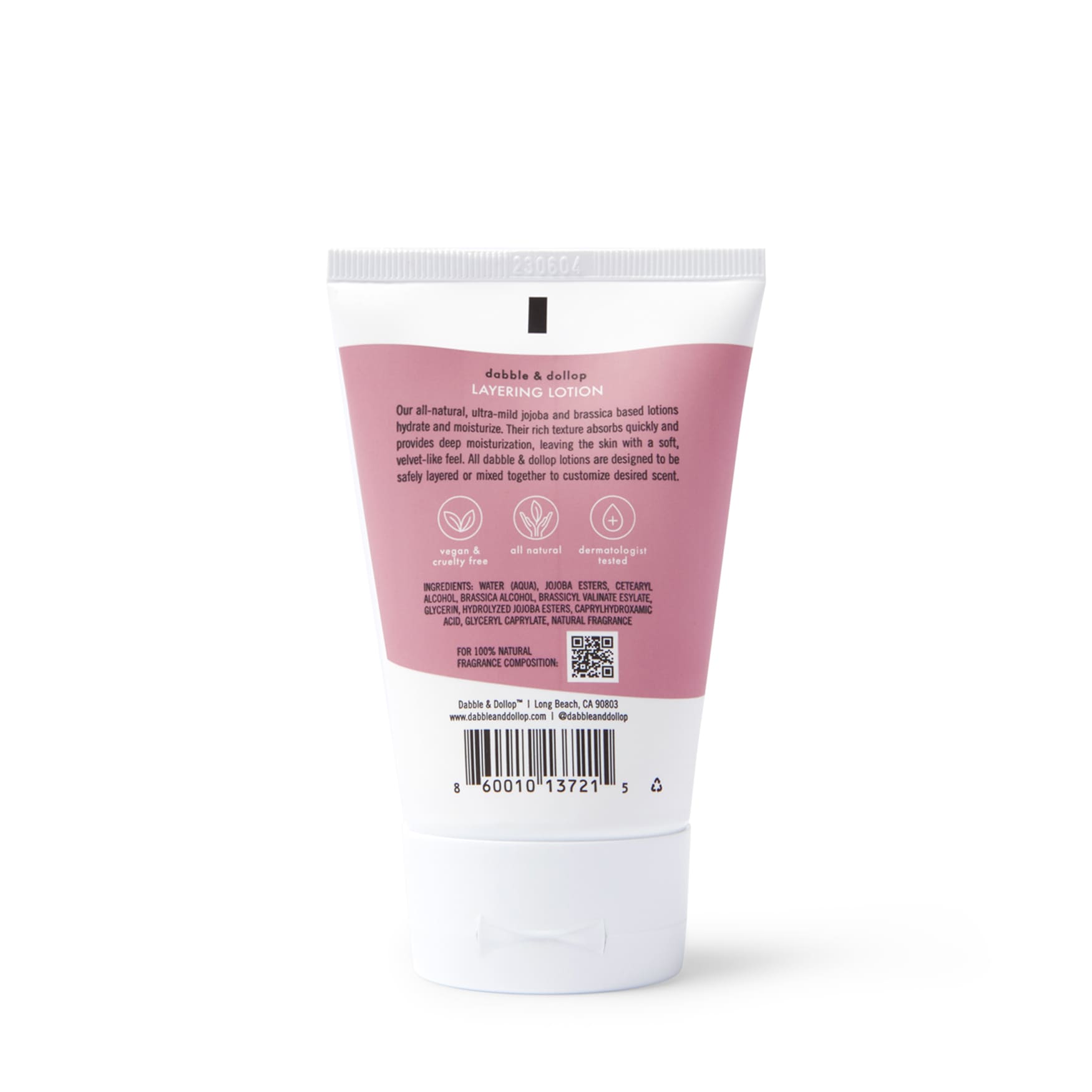 The image displays a pink and white tube of Dabble & Dollops Coconut Body Lotion. The back lists details, ingredients, symbols for vegan and cruelty-free status, and a barcode highlighting its all-natural coconut scent.