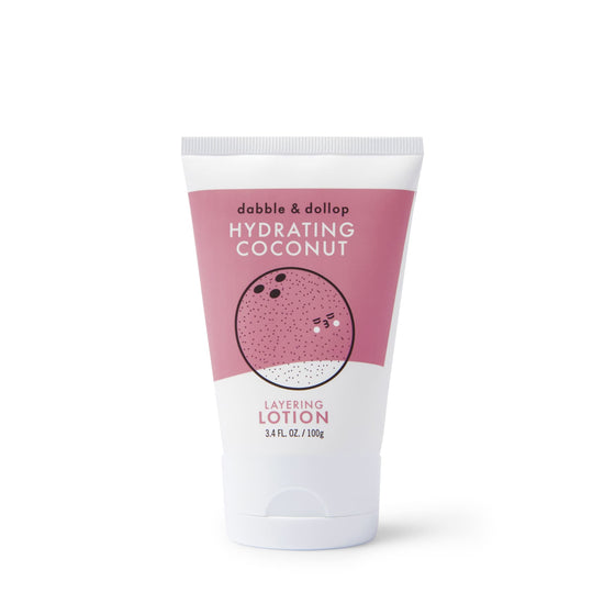The Dabble & Dollop Coconut Body Lotion tube, with a pink label displaying a charming coconut illustration, offers an all-natural 3.4 fl oz (100g) lotion experience that envelops your skin in a delightful coconut scent.
