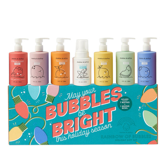 Celebrate the season with the Dabble & Dollop Holiday Rainbow of Bubbles Bath Gift Set—seven brightly labeled foaming soap bottles in festive fruit or vanilla scents, each crafted from plant-based ingredients. The vibrant set is displayed above a cheery box reading “May your bubbles bright this holiday season.” Mix, match, and indulge in a joyful bubble bath experience!.