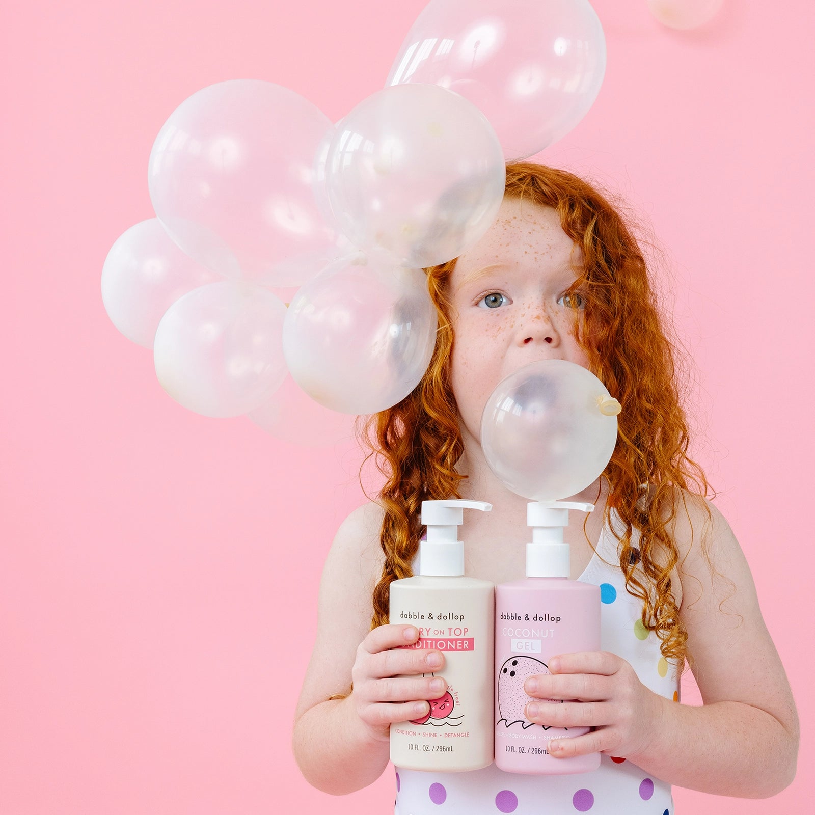 Girl blowing bubble holding bath products