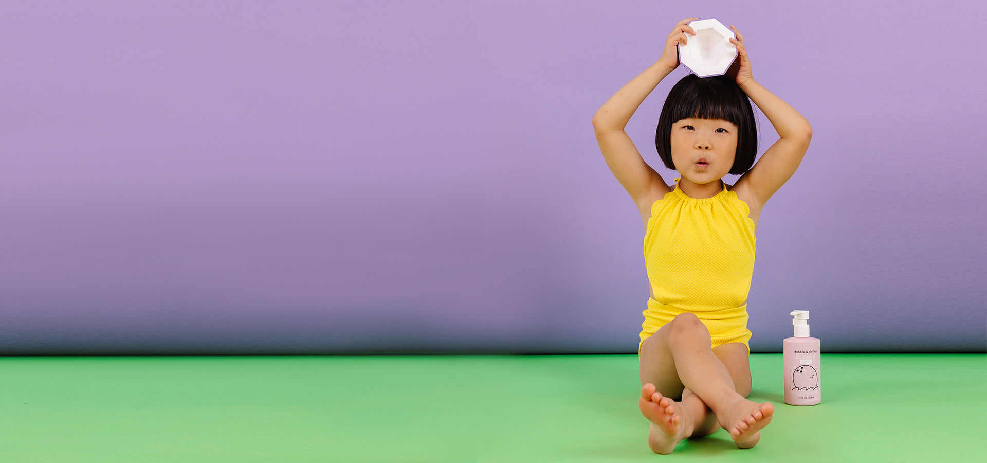 Little girl sitting with coconut gel and paper coconut