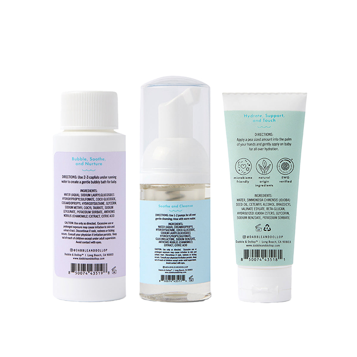 Three Dabble & Dollop Bundle of Joy Minis Kit bottles with pastel labels are shown backward, displaying usage directions and ingredients. The kit includes a white cap bottle, a clear pump bottle, and a white tube for gentle baby skincare.