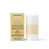 A Dabble & Dollop Barrier Boost Skin Barrier Soothing Stick is placed beside its box. Both are white with teal and yellow labels displaying the product name, brand, and instructions for use.