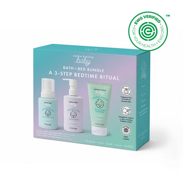 A pastel box displays the Baby Bath to Bed Gift Set by Dabble & Dollop, a three-step bedtime ritual featuring bath gel, lotion, and oil—perfect for sensitive baby skin. The packaging includes step icons and an EWG Verified health logo in the upper right corner.