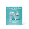 The Dabble & Dollop Bundle of Joy Minis Kit is a teal box with three fragrance-free, travel-size baby care products—bottle, tube, and foam dispenser—all in light blue and white packaging for gentle care.