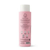 A pink Dabble & Dollop Coconut Bubble Bath bottle for kids, shown from the back with white text, icons, and instructions. The white cap tops the bottle, which features a smiling droplet line drawing—perfect for a tropical bath.