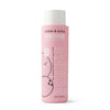 A 16 fl oz bottle of Dabble & Dollop Coconut Bubble Bath features playful coconut illustrations and white text on a pink label. This all-natural, hypoallergenic, and tear-free formula is perfect for gentle, bubbly fun at bath time.