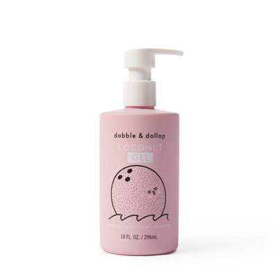 A pink pump bottle labeled Dabble & Dollop Coconut Bubble Bath, Body Wash & Shampoo features a smiling coconut. This 10 fl oz 3-in-1 product cleanses and bubbles with an all-natural coconut scent.
