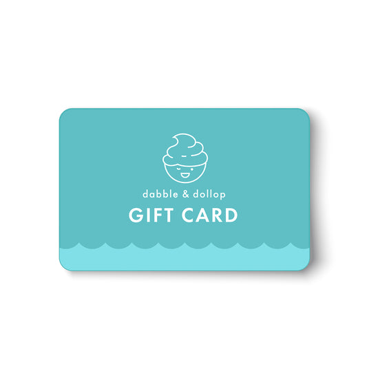 A turquoise Dabble & Dollop Gift Card e-gift, with a smiling swirl line drawing and wave pattern, is perfect for gifting plant-based products. Text reads dabble & dollop GIFT CARD on a white background.