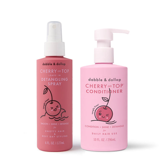 The Dabble & Dollop Cherry on Top® Detangling Duo Bundle includes a 10 fl oz kids conditioner with pump and a 6 fl oz detangling spray, both in pink bottles with a cherry design for easy, tangle-free hair.