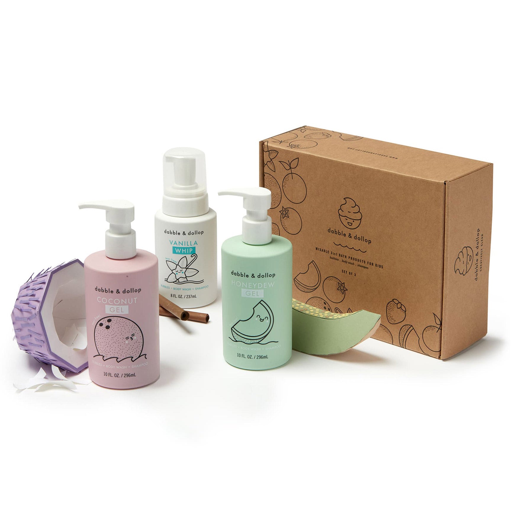 The Dabble & Dollop A Day at the Beach Bath Bundle—ideal as shampoo, bubble bath, or body wash—is shown with a decorative box, a purple sponge, and green and beige paper accessories on a white background.