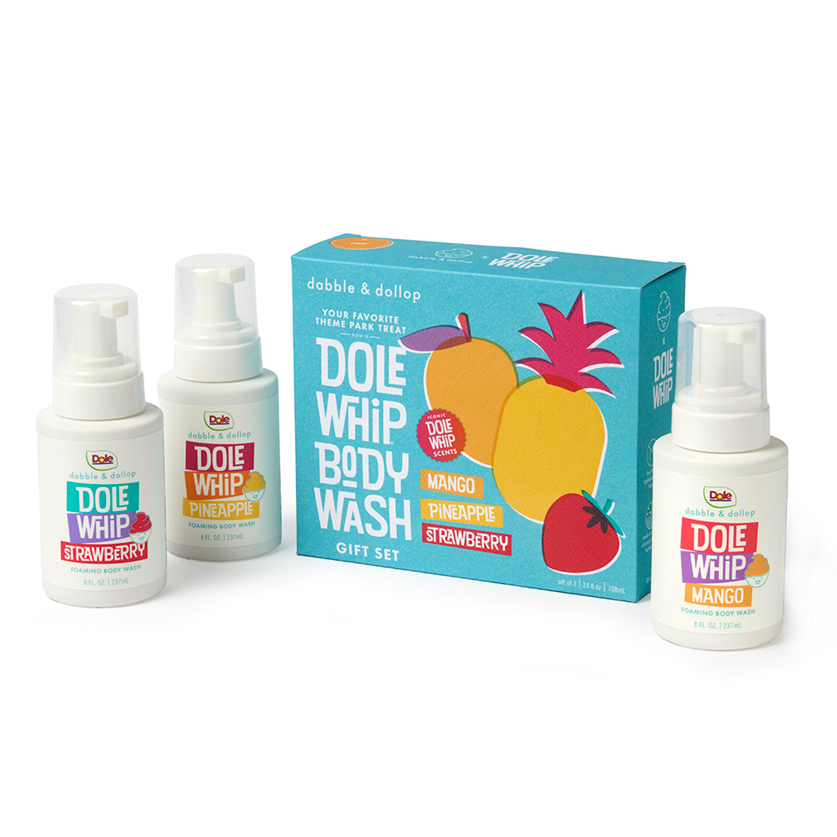 Three bottles of Dabble & Dollop Bath Gift Sets body wash—featuring strawberry, pineapple, and mango scents—are displayed with a vibrant gift box decorated with fruit illustrations and the product name, making them perfect for bath gift sets or for individuals with sensitive skin.
