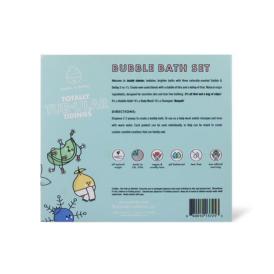 Dabble & Dollop’s Totally Tub-ular Tidings Bubble Bath Set—Strawberry, Honeydew & Vanilla—comes in light blue packaging with winter birds, listing set details, bath directions, and icons for plant-based, vegan, and paraben-free ingredients.