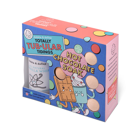 Colorful packaging for the Totally Tub-ular Tidings Bubble Bath Set by Dabble & Dollop features cartoon marshmallow, chocolate, and whipped cream characters, plus a window showing bath bombs inside—making it a perfect holiday gift set.