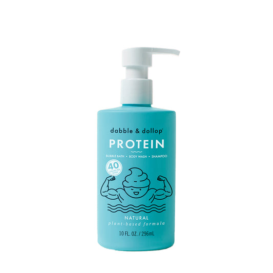 A 10 fl oz blue pump bottle of Dabble & Dollop Protein Bubble Bath, Body Wash & Shampoo features a cartoon flexing swirl and is labeled as natural and plant-based.