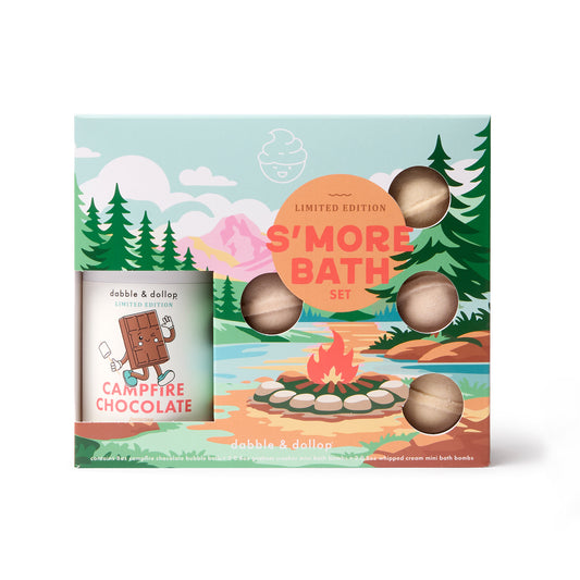 The Dabble & Dollop S'more Bath Set is a limited edition kids bath set featuring a campfire and forest-themed box with five round bath bombs visible through cutouts, plus a Campfire Chocolate bubble bath.