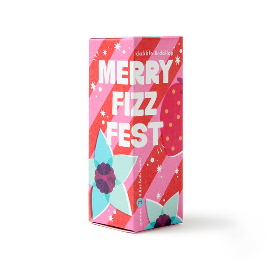 The Merry Fizzfest Mini Drops Stocking Stuffer by Dabble & Dollop comes in a vibrant, festively designed box featuring flowers and stars in pink, red, and teal accents. This cheerful set includes three 3 oz bath bombs—an ideal holiday gift or fun stocking stuffer.