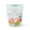 A pastel pouch of Dabble & Dollop Tropical Mini Bath Bombs features cute fruit illustrations and product info on the back, with a clear window that displays round bath bombs made from natural ingredients inside.