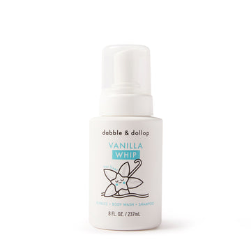 A white bottle of Dabble & Dollop Foaming Wash & Bubble Bath features a charming illustrated vanilla flower and text indicating it can be used as bubbles, body wash, and shampoo. The bottle contains 8 fl. oz. (237 mL).