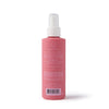 A pink spray bottle labeled "Cherry on Top Leave-In Spray Detangler" by Dabble & Dollop, ideal for kids' hair care. Features a white spray top with directions and ingredients—perfect as a gentle detangling spray. Stands upright on a white background.