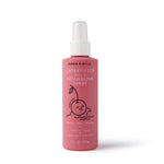 A pink 6 fl. oz. bottle of Dabble & Dollop Cherry on Top® Leave-In Spray Detangler for kids, with a cartoon cherry and white nozzle, is perfect for knotty hair.